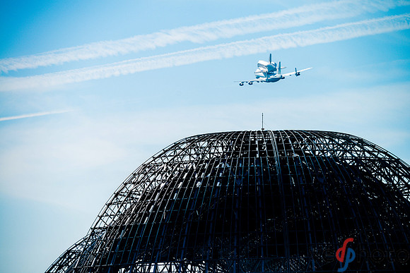 Space Shuttle Endeavour flying over NASA Ames hangar